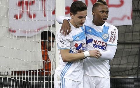 Marseille's forward Florian Thauvin, second right, reacts with Marseille's forward Clinton Mua Njie, after scoring during the League One soccer match between Marseille and Angers, at the Velodrome Stadium, Friday, March 10, 2017. (AP Photo/Claude Paris)