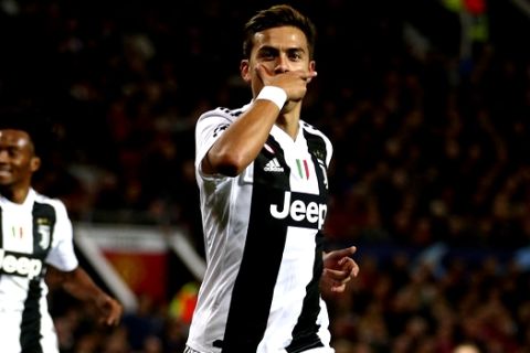 Juventus forward Paulo Dybala celebrates after scoring the opening goal during the Champions League group H soccer match between Manchester United and Juventus at Old Trafford, Manchester, England, Tuesday, Oct. 23, 2018. (AP Photo/Dave Thompson)