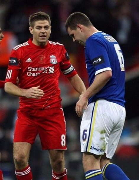 Liverpool's Steven Gerrard goes over to console his cousin, Cardiff City's Anthony Gerrard, after he missed the deciding penalty during the League Cup Final at Wembley Stadium, London Sunday Feb. 26, 2012. (AP Photo/Nick Potts/PA ) UNITED KINGDOM OUT  NO SALES  NO ARCHIVE