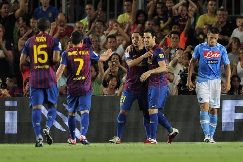 Barcelona's midfielder Cesc Fabregas (C) is congratuled by his teamates after scoring during their 46th Trophy Joan Gamper friendly football match against Napoli at Camp Nou stadium in Barcelona on August 22, 2011. AFP PHOTO / JOSEP LAGO (Photo credit should read JOSEP LAGO/AFP/Getty Images)