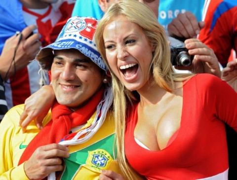 A Paraguayan(R) and a Brazilian supporter pose together before a 2011 Copa America Group B first round football match held at the Mario Kempes stadium in Cordoba, 770 Km northwest of Buenos Aires, on July 9, 2011. AFP PHOTO / MIGUEL ROJO