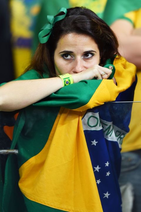 BELO HORIZONTE, BRAZIL - JULY 08: A dejected Brazil fan looks on during the 2014 FIFA World Cup Brazil Semi Final match between Brazil and Germany at Estadio Mineirao on July 8, 2014 in Belo Horizonte, Brazil.  (Photo by Buda Mendes/Getty Images)