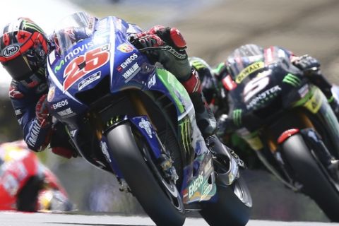 MotoGP rider Maverick Vinales of Spain steers his motorcycle as he is followed by Johann Zarco of France during the French Grand Prix's race, in Le Mans, western France, Sunday, May 21, 2017. (AP Photo/David Vincent)