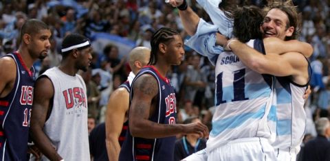 ** FILE ** Argentina's Fabricio Oberto, right, is lifted by teammate Luis Scola after a 89-81 defeat of the United States in their semi-final game at the Olympic Indoor Hall during the 2004 Olympics in Athens, Greece on Friday, Aug. 27, 2004. U.S. players from left: Tim Duncan, Lebron James and Carmelo Anthony. The San Antonio Spurs have signed Oberto whose soft hands, smooth touch and strong basketball IQ will add another low-post weapon to their roster.(AP Photo/Dusan Vranic, File)
