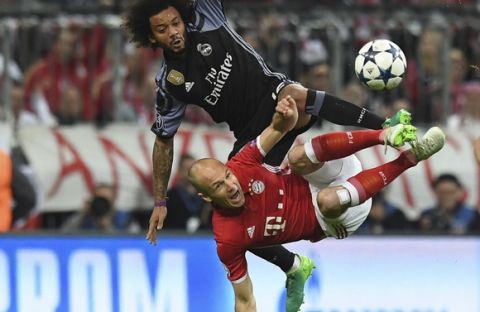 Munich's Arjen Robben, bottom, and Real Madrid's Marcelo, top, challenge for the ball during the Champions League quarterfinal first leg soccer match between FC Bayern Munich and Real Madrid, in Munich, Germany, Wednesday, April 12, 2017. (Matthias Balk/dpa via AP)
