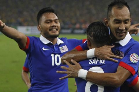 Malaysian team players celebrate their third goal against Thailand during their final second leg soccer match of the AFF Suzuki Cup 2014 at Bukit Jalil National Stadium in Kuala Lumpur, Malaysia, Saturday, Dec. 20, 2014. (AP Photo/Lai Seng Sin)