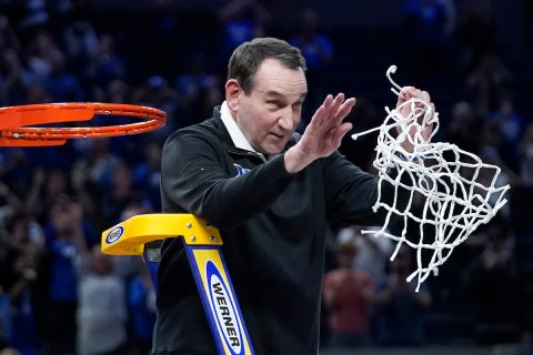 Duke head coach Mike Krzyzewski celebrates while cutting down the net after Duke defeated Arkansas in a college basketball game in the Elite 8 round of the NCAA mens tournament in San Francisco, Saturday, March 26, 2022. (AP Photo/Marcio Jose Sanchez)