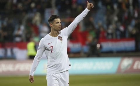 Portugal's Cristiano Ronaldo celebrates his team's 2-0 victory at the end of the Euro 2020 group B qualifying soccer match between Luxembourg and Portugal at the Josy Barthel stadium in Luxembourg, Sunday, Nov. 17, 2019. (AP Photo/Francisco Seco)