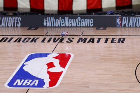 An empty court and bench are shown following the scheduled start time of Game 5 of an NBA basketball first-round playoff series, Wednesday, Aug. 26, 2020, in Lake Buena Vista, Fla. All three NBA playoff games scheduled for Wednesday were postponed, with players around the league choosing to boycott in their strongest statement yet against racial injustice.  (Kevin C. Cox/Pool Photo via AP)