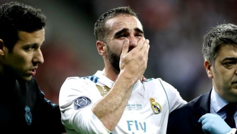 Real Madrid's Daniel Carvajal reacts as he leaves the pitch after being injured during the Champions League Final soccer match between Real Madrid and Liverpool at the Olimpiyskiy Stadium in Kiev, Ukraine, Saturday, May 26, 2018. (AP Photo/Matthias Schrader)