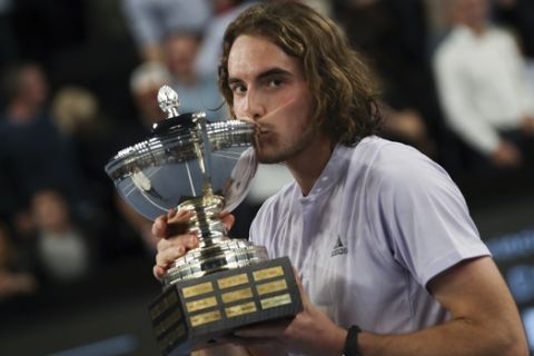 Stefanos Tsitsipas of Greece celebrates with the trophy after winning the men's singles final of the Open 13 Provence tennis tournament against Felix Auger-Aliassime of Canada in two sets, 6-3, 6-4, in Marseille, southern France, Sunday, Feb. 23, 2020. (AP Photo/Daniel Cole)