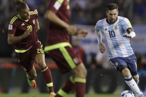 Chased by Venezuela's Rolf Feltscher, left, Argentina's Lionel Messi controls the ball during a 2018 World Cup qualifying soccer match in Buenos Aires, Argentina, Tuesday, Sept. 5, 2017.(AP Photo/Natacha Pisarenko)