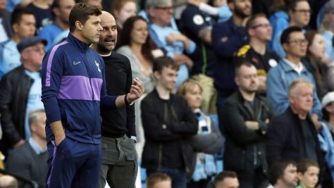 Tottenham's manager Mauricio Pochettino, left, speaks with Manchester City's head coach Pep Guardiola during the English Premier League soccer match between Manchester City and Tottenham Hotspur at Etihad stadium in Manchester, England, Saturday, Aug. 17, 2019. (AP Photo/Rui Vieira)