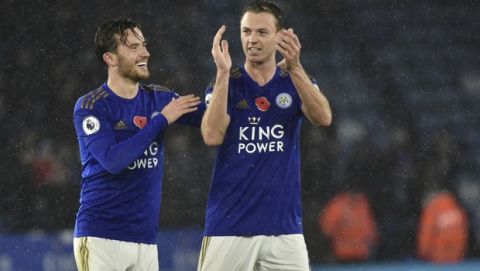 Leicester's Ben Chilwell, left, and Leicester's Jonny Evans celebrate their victory at the end of the English Premier League soccer match between Leicester City and Arsenal at the King Power Stadium in Leicester, England, Saturday, Nov. 9, 2019. (AP Photo/Rui Vieira)