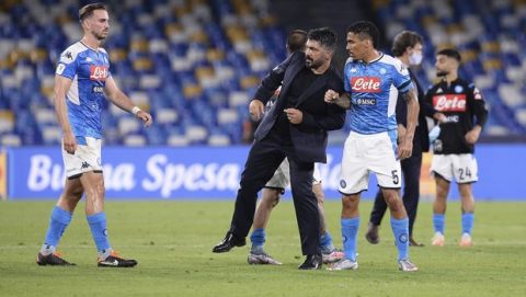 Napoli's head coach Gennaro Gattuso, center, celebrates with his players after an Italian Cup second leg semifinal soccer match between Napoli and Inter Milan, at the Naples San Paolo Stadium in Naples, Italy, Saturday, June 13, 2020. The match was played without spectators because of the COVID-19 restriction measures. (Cafaro/LaPresse via AP)