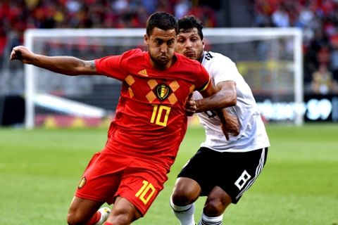 Belgium's Eden Hazard, left, is pursued by Egypt's Tarek Hamed during a friendly soccer match between Belgium and Egypt at the King Baudouin stadium in Brussels, Wednesday, June 6, 2018. (AP Photo/Geert Vanden Wijngaert)