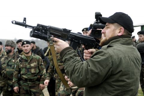 Ramzan Kadyrov proudly displays his shooting skills at a firing range in his village of Tsentoroi in front of members of his private army. Officially his army are known as the anti-terrorism squad, but everyone refers to its soldiers as Kadyrovtsy - "Kadyrov's guys". November 2005.

Ramzan was born 5 October 1976 in Tsenteroi, Chechnya, and was made Prime Minister of Chechnya in the beginning of March 2006 and leader of a powerful Chechen militia known as kadyrovtsy. He is the son of former Chechen President Akhmad Kadyrov, who was assassinated in May 2004. He has the backing of Russian President Vladimir Putin, and was awarded the Hero of Russia medal, the highest honorary title of the Russian Federation. As the head of the Chechen Presidential Security Service, Kadyrov has often been accused of being brutal, ruthless and antidemocratic; according to media and human rights groups, he was personally implicated in several instances of torture and murder. It is also rumored that he owns a private prison in his stronghold village of Tsenteroi, where he uses inmates as a punching bags. Kadyrov is known for keeping a pet lion cub, given to him as a gift after the birth of his first son, as well as a tiger and a number of a fighting dogs, and also used to own a wolf and a bear. He has only a few classes of elementary education finished; despite his lack of education, Kadyrov is a honorary member of the Russian Academy of Sciences.                                