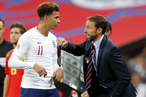 England manager Gareth Southgate talks with England's Dele Alli during the UEFA Nations League soccer match between England and Spain at Wembley stadium in London, Saturday Sept. 8, 2018. (AP Photo/Frank Augstein)
