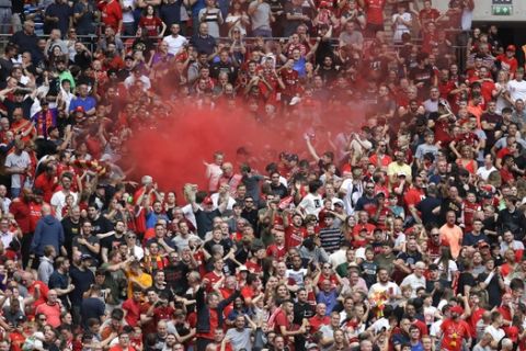 Liverpool's fans celebrate the equalizer scored by Liverpool's Joel Matip during the English Community Shield soccer match between Liverpool and Manchester City at Wembley stadium in London, Sunday, Aug. 4, 2019. (AP Photo/Kirsty Wigglesworth)