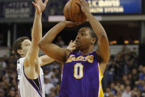 Los Angeles Lakers guard Andrew Goudelock, right, shoots against Sacramento Kings guard Jimmer Fredette, during the first half of an NBA basketball game in Sacramento, Calif., April 26, 2012.  The Kings won 113-96.(AP Photo/Rich Pedroncelli)
