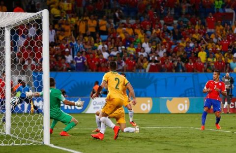 CUIABA, BRAZIL - JUNE 13: Alexis Sanchez of Chile shoots and scores against goalkeeper Mathew Ryan of Australia during the 2014 FIFA World Cup Brazil Group B match between Chile and Australia at Arena Pantanal on June 13, 2014 in Cuiaba, Brazil.  (Photo by Matthew Lewis/Getty Images)
