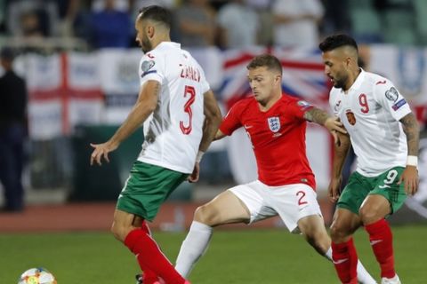 Bulgaria's Wanderson, right, and Bulgaria's Petar Zanev, left, fight for the ball with England's Kieran Trippier during the Euro 2020 group A qualifying soccer match between Bulgaria and England, at the Vasil Levski national stadium, in Sofia, Bulgaria, Monday, Oct. 14, 2019. (AP Photo/Vadim Ghirda)