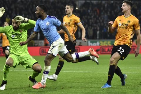 Manchester City's Raheem Sterling scores his side's second goal during the English Premier League soccer match between Wolverhampton Wanderers and Manchester City at the Molineux Stadium in Wolverhampton, England, Friday, Dec. 27, 2019. (AP Photo/Rui Vieira)