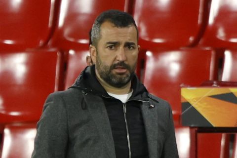 Granada's head coach Diego Martinez stands near the bench during the Europa League, quarterfinal, first leg soccer match between Granada and Manchester United at the Los Carmenes stadium in Granada, Spain, Thursday, April 8, 2021. (AP Photo/Fermin Rodriguez)