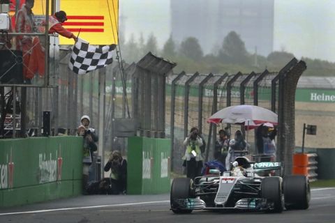 Mercedes driver Lewis Hamilton of Britain gets the checkered flag to win the Chinese Formula One Grand Prix at the Shanghai International Circuit in Shanghai, China, Sunday, April 9, 2017. (AP Photo/Mark Schiefelbein)