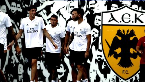 Benfica's German Conti, left, arrives with teammates for a training session at Athens' Olympic stadium Monday, Oct. 1, 2018. Benfica will face AEK in a Champions League, Group E  soccer match on Tuesday. (AP Photo/Petros Giannakouris)