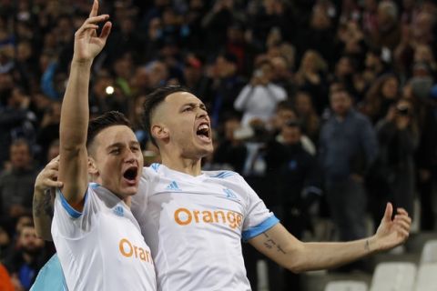 Marseille's Florian Thauvin, left, and Marseille's Lucas Ocampo, right, celebrates after Ocampo scored the opening goal of his team during the Europa League round of 16, 1st leg soccer match between Marseille and Athletic Bilbao, at the Velodrome stadium, in Marseille, southern France, Thursday March 8, 2018. (AP Photo/Claude Paris)