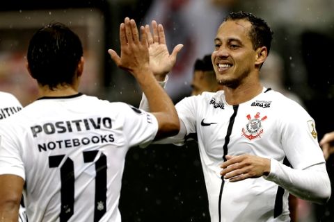 Rodriguinho of Brazil's Corinthians, right, celebrates with teammate Angel Romero after scoring against Venezuela's Deportivo Lara, during a Copa Libertadores soccer match in Sao Paulo, Brazil, Wednesday, March 14, 2018. (AP Photo/Andre Penner)