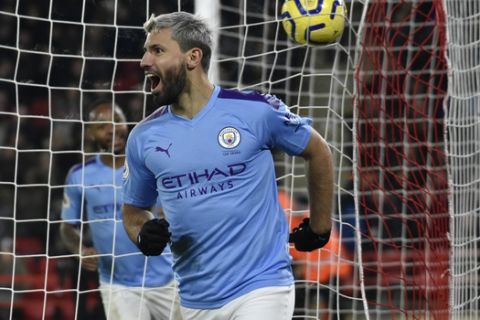 Manchester City's Sergio Aguero celebrates after scoring his side's opening goal during the English Premier League soccer match between Sheffield United and Manchester City at Bramall Lane in Sheffield, England, Tuesday, Jan. 21, 2020. (AP Photo/Rui Vieira)