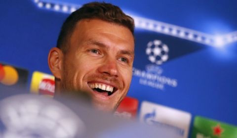 Roma's Edin Dzeko smiles during a press conference one day ahead of the Champions League Group C soccer match between Chelsea and Roma at Stamford Bridge stadium in London, England, Tuesday, Oct. 17, 2017. (AP Photo/Frank Augstein))