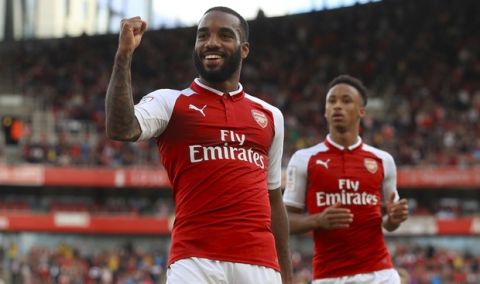 Arsenal's Alexandre Lacazette celebrates scoring his side's first goal of the game during the Emirates Cup soccer match Arsenal against Sevilla FC at the Emirates Stadium, London, Sunday, July 30, 2017. (John Walton/PA via AP)