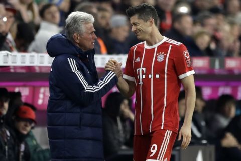 Bayern coach Jupp Heynckes, left, talks to Bayern's Robert Lewandowski during the German Soccer Bundesliga match between FC Bayern Munich and RB Leipzig in Munich, Germany, Saturday, Oct. 28, 2017. (AP Photo/Matthias Schrader)