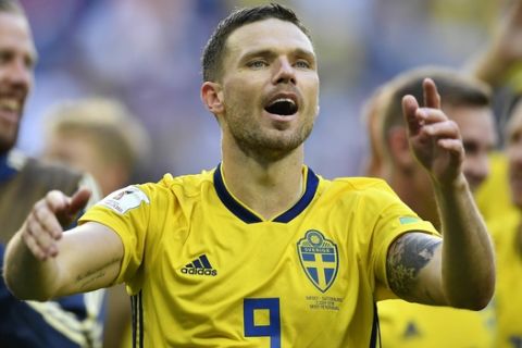 Sweden's Marcus Berg celebrates with teammates after winning the round of 16 match between Switzerland and Sweden at the 2018 soccer World Cup in the St. Petersburg Stadium, in St. Petersburg, Russia, Tuesday, July 3, 2018. (AP Photo/Martin Meissner)