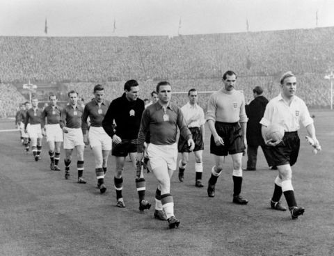 The teams coming out, led by the two captains, Billy Wright of England, right, and Ferenc Puskas of Hungary.