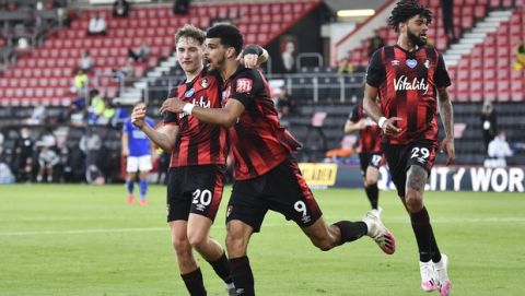 Bournemouth's Dominic Solanke, centre, is congratulated by teammate David Brooks, left, after scoring his team's second goal during the English Premier League soccer match between Bournemouth and Leicester City at Vitality Stadium in Bournemouth, England, Sunday, July 12, 2020. (AP Photo/Glynn Kirk,Pool)