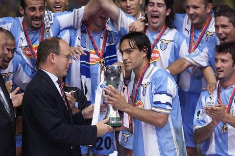 Players from the Italian soccer team Lazio of Rome celebrate as Prince Albert of Monaco (L) presents the trophy to their captain Alessandro Nesta, 27 August, 1999 in Monaco, after Lazio beat Manchester in the UEFA Super Cup soccer final.       
ANSA/PASCAL GUYOT