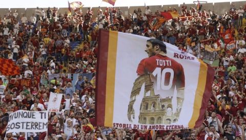Roma fans show flags and banner for captain Francesco Totti prior to an Italian Serie A soccer match between Roma and Genoa at the Olympic stadium in Rome, Sunday, May 28, 2017. Francesco Totti is playing his final match with Roma against Genoa after a 25-season career with his hometown club. (AP Photo/Alessandra Tarantino)