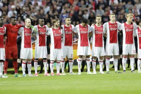 Ajax's team observe a minute of silence to commemorate the victims of the Manchester attack prior to the soccer Europa League final between Ajax Amsterdam and Manchester United at the Friends Arena in Stockholm, Sweden, Wednesday, May 24, 2017. (AP Photo/Michael Sohn)