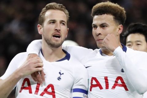 Tottenham's Harry Kane, left, celebrates with teammate Dele Alli after scoring his side first goal during the English League Cup semifinal first leg soccer match between Tottenham Hotspur and Chelsea at Wembley Stadium in London, Tuesday, Jan. 8, 2019. (AP Photo/Frank Augstein)