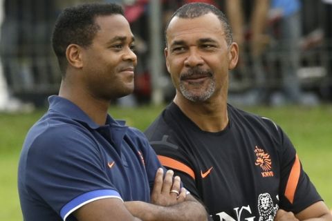 Assistant Coach Patrick Kluivert of the Netherlands soccer team, left, confers with former Dutch soccer star Ruud Gullit during a coaching clinic for Indonesian youths in Jakarta, Indonesia, Thursday, June 6, 2013.  (AP Photo/Dita Alangkara)