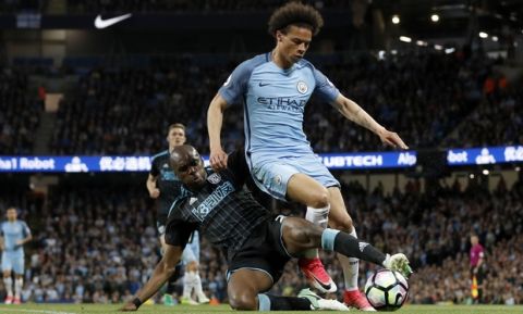 West Bromwich Albion's Allan Nyom, left, and Manchester City's Leroy Sane battle for the ball  during the English Premier League soccer match against Manchester City at the Etihad Stadium, Manchester, England, Tuesday May 16, 2017. (Martin Rickett/PA via AP)