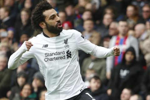 Liverpool's Mohamed Salah celebrates after soring his sides second goal of the gameduring their English Premier League soccer match between Crystal Palace and Liverpool at Selhurst Park stadium in London, Saturday, March, 31, 2018. Liverpool won the game 2-1. (AP Photo/Alastair Grant)