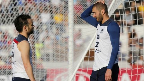 FILE - In this June 10, 2014 file photo, France's Mathieu Valbuena, left, and Karim Benzema, right, chat during a training session of the french national soccer team, at the Santa Cruz Stadium in Ribeirao Preto, Brazil. Speaking publicly for the first time since becoming embroiled in a blackmail scandal, Karim Benzema said Wednesday Dec.2, 2015 he wants to play again for France and win the 2016 European Championship with teammate Mathieu Valbuena. (AP Photo/David Vincent, File)