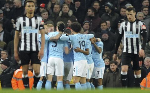 Manchester City players celebrate after Sergio Aguero scored the opening goal during the English Premier League soccer match between Manchester City and Newcastle United at the Etihad Stadium in Manchester, England, Saturday, Jan. 20, 2018. (AP Photo/Rui Vieira)