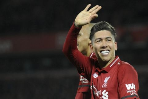 Liverpool's Roberto Firmino celebrates after he scores his sides 5th goal and his 3rd from the penalty spot during the English Premier League soccer match between Liverpool and Arsenal at Anfield in Liverpool, England, Saturday, Dec. 29, 2018. (AP Photo/Rui Vieira)