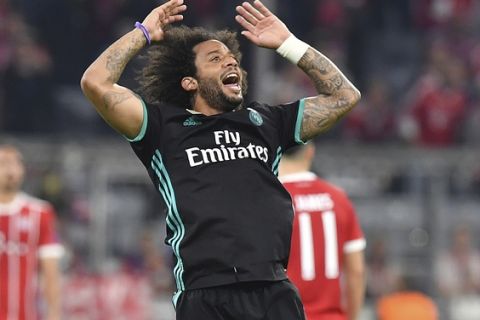 Real Madrid's Marcelo celebrates his equalizing goal during the semifinal first leg soccer match between FC Bayern Munich and Real Madrid at the Allianz Arena stadium in Munich, Germany, Wednesday, April 25, 2018. (AP Photo/Kerstin Joensson)